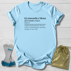 Light blue t-shirt with 'Gymnastics Mom' definition text, socks, and drawstring bag on a light wooden surface.