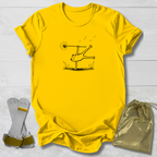 Yellow t-shirt with a graphic design on a light wooden surface