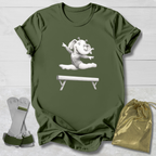 Green t-shirt with a cartoon elephant design, socks, and a drawstring bag on a light wooden surface.