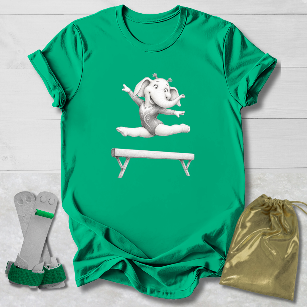Green t-shirt with a cartoon elephant on a balance beam, socks, and a drawstring bag on a light wooden surface.