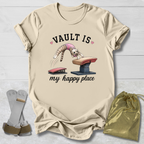 Beige t-shirt with graphic design and accessories on a light wooden surface