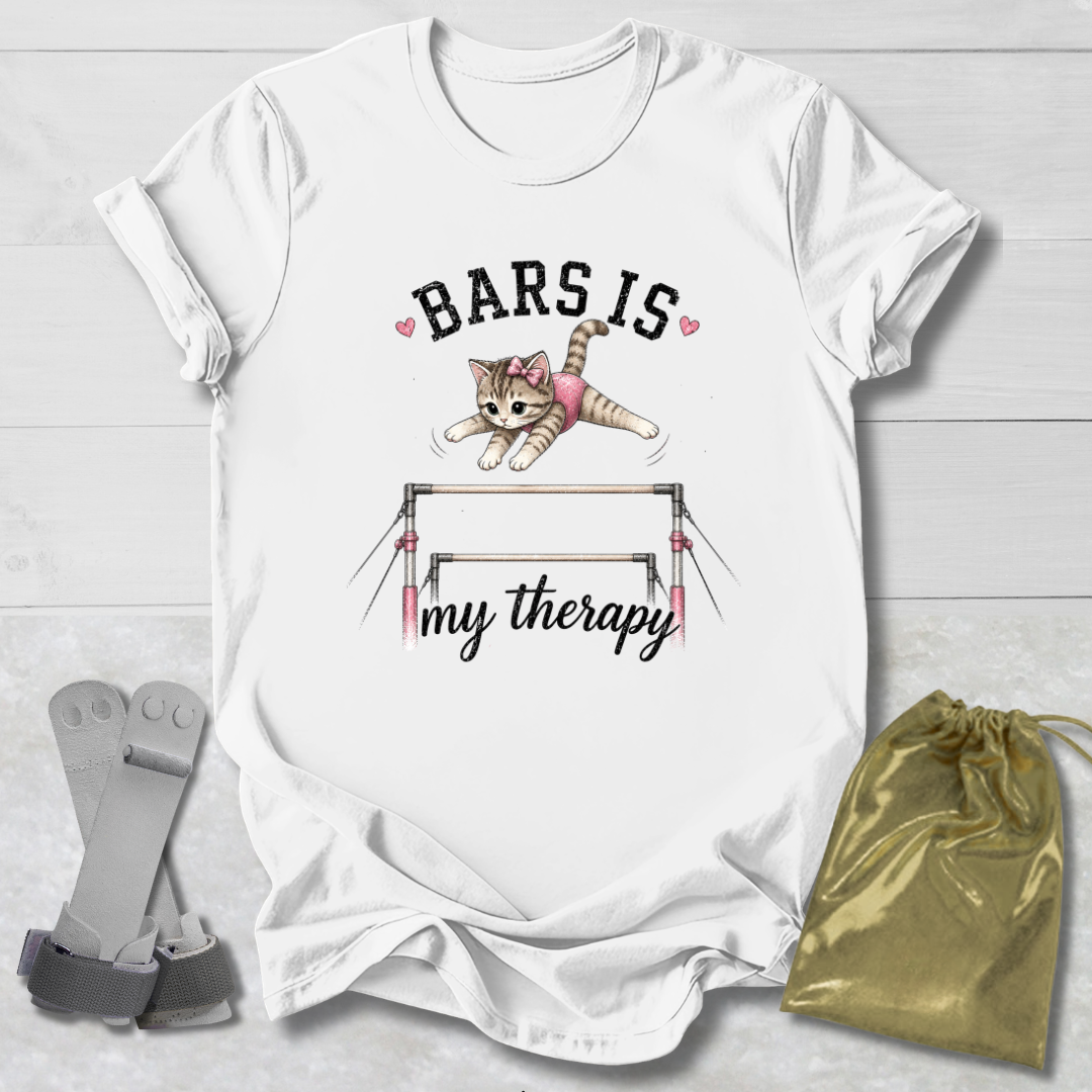 White t-shirt with a graphic of a cat on bars and text, placed on a light wooden surface with socks and a drawstring bag.