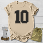 Beige t-shirt with number 10, socks, and drawstring bag on a light wooden surface
