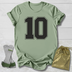 Green t-shirt with number 10, socks, and drawstring bag on a light wooden surface