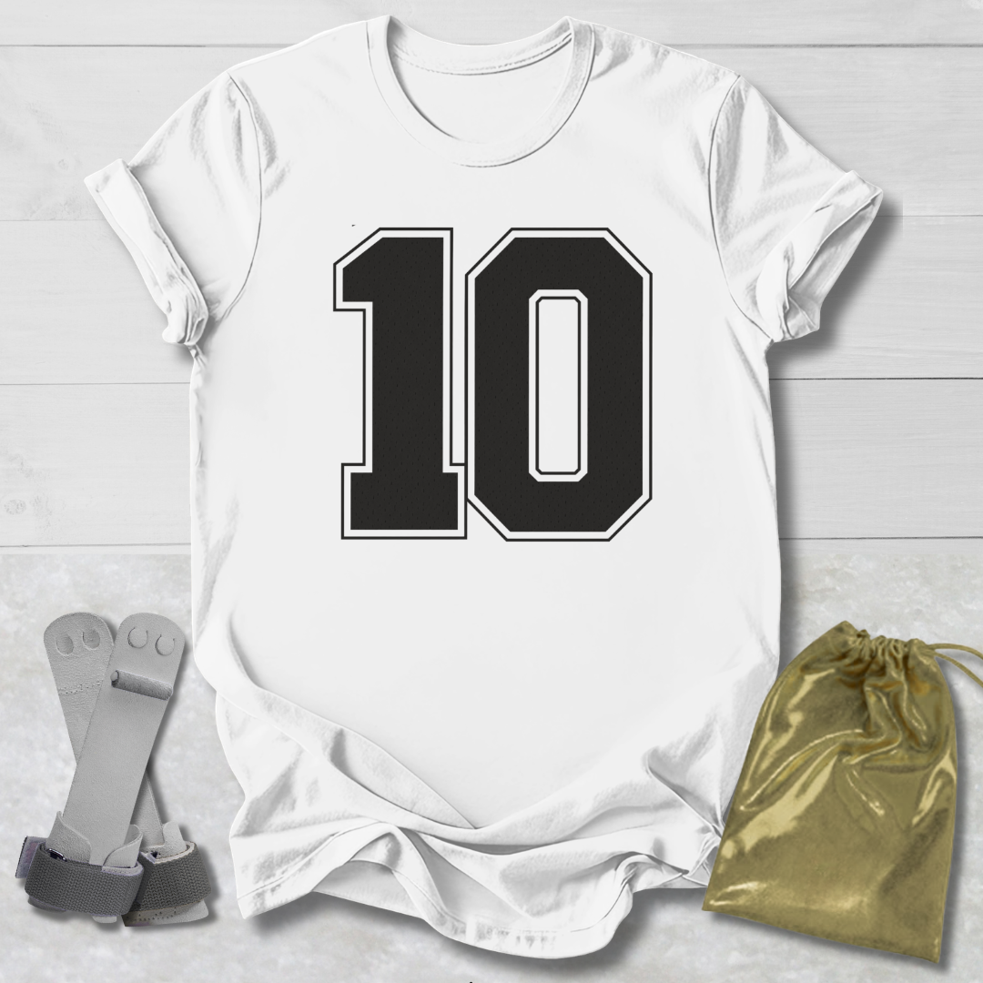White t-shirt with black number 10 design on a light wooden surface, with socks and a drawstring bag in the foreground.
