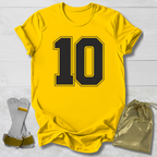 Yellow t-shirt with the number 10, socks, and a drawstring bag on a light wooden surface.
