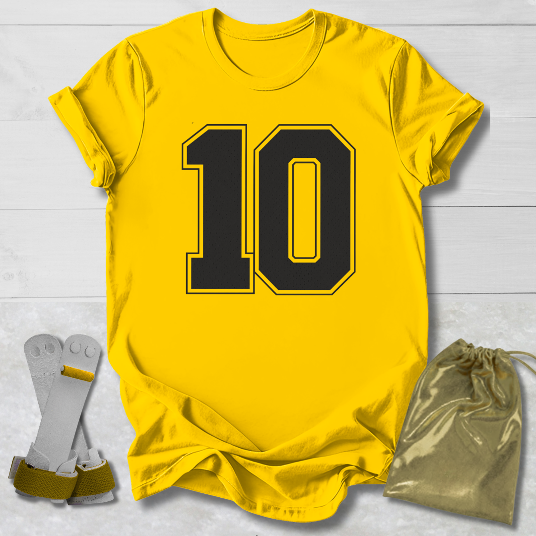 Yellow t-shirt with the number 10, socks, and a drawstring bag on a light wooden surface.