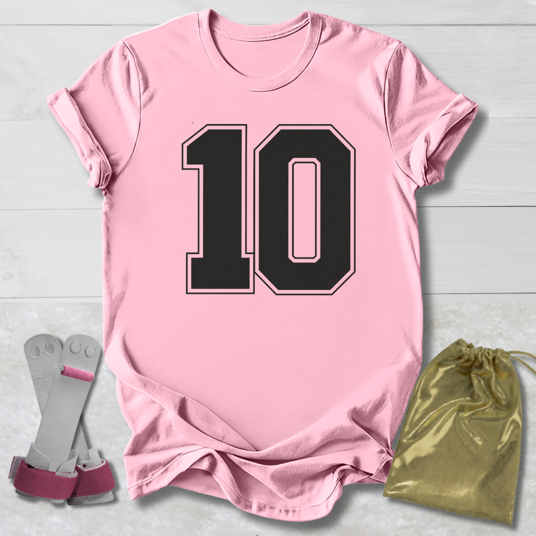 Pink t-shirt with black number 10, gray socks, and gold drawstring bag on a light wooden surface.