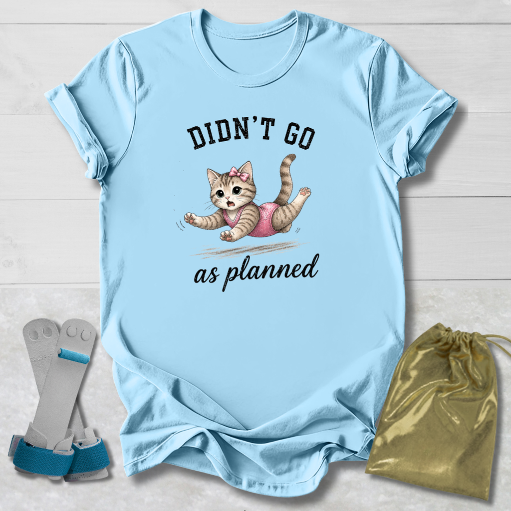 Light blue t-shirt with a kitten graphic and text, socks, and a drawstring bag on a wooden surface.