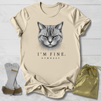 Beige t-shirt with a cat graphic and text, socks, and drawstring bag on a light wooden surface.