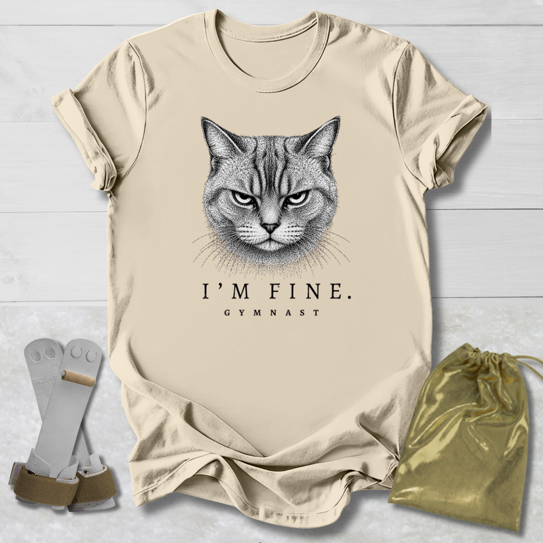 Beige t-shirt with a cat graphic and text, socks, and drawstring bag on a light wooden surface.