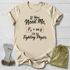 Beige t-shirt with humorous physics text, socks, and drawstring bag on a light wooden surface