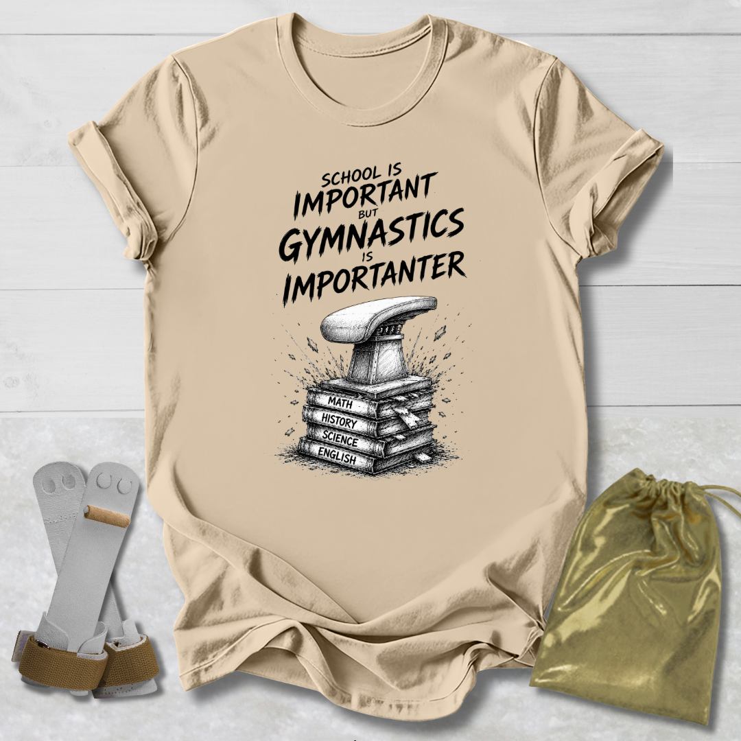 Beige t-shirt with gymnastics-themed text and graphic, socks, and drawstring bag on a light wooden surface.