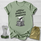 Green t-shirt with gymnastics-themed design and accessories on a light wooden surface