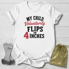 White t-shirt with humorous text design on a light wooden surface, accompanied by gray socks and a gold drawstring bag.