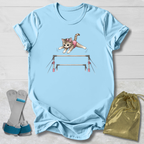 Light blue t-shirt with a cat graphic on a wooden surface, accompanied by socks and a drawstring bag.
