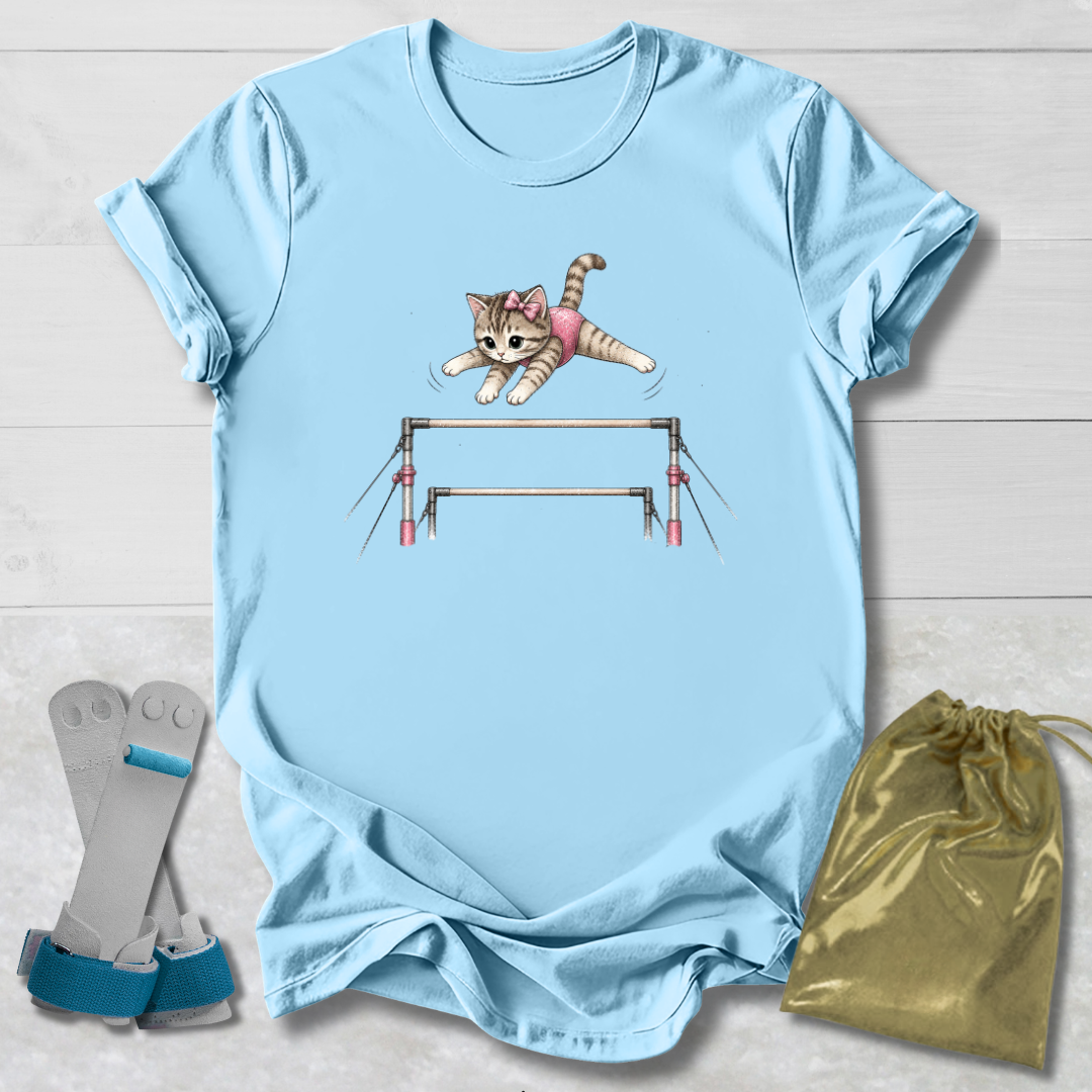 Light blue t-shirt with a cat graphic on a wooden surface, accompanied by socks and a drawstring bag.