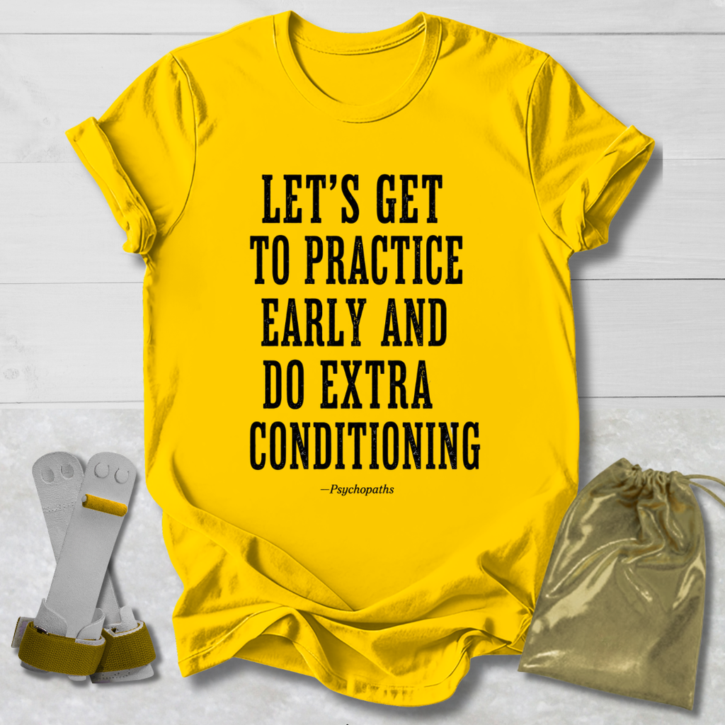 A bright yellow graphic T-shirt laid flat on a white wood background, with bold black text reading “LET’S GET TO PRACTICE EARLY AND DO EXTRA CONDITIONING” and a small “~Pypchopaths” signature underneath. A white and gold athletic strap accessory and a metallic gold drawstring pouch are placed beside the shirt as styling props.