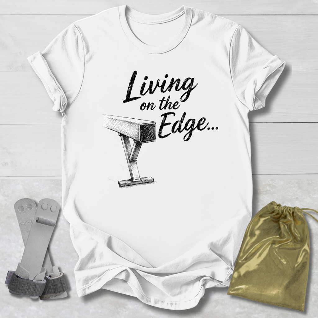 white graphic T-shirt laid flat on a white wood background, printed with the words 'Living on the Edge.