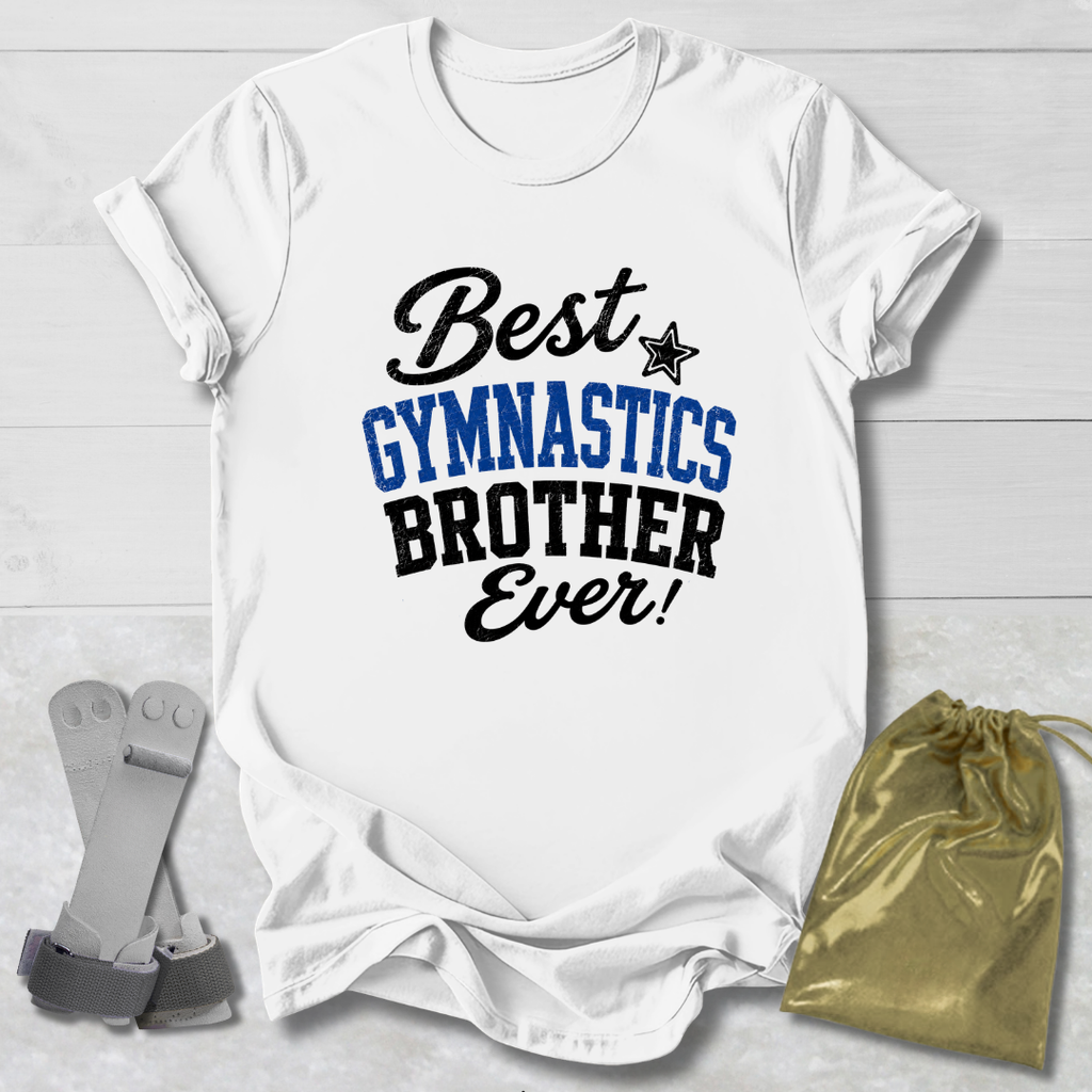 A white short-sleeve T-shirt laid flat on a light wood background, printed with the phrase 'Best GYMNASTICS BROTHER Ever!' in black and blue lettering. A small black star appears between 'Best' and 'GYMNASTICS.