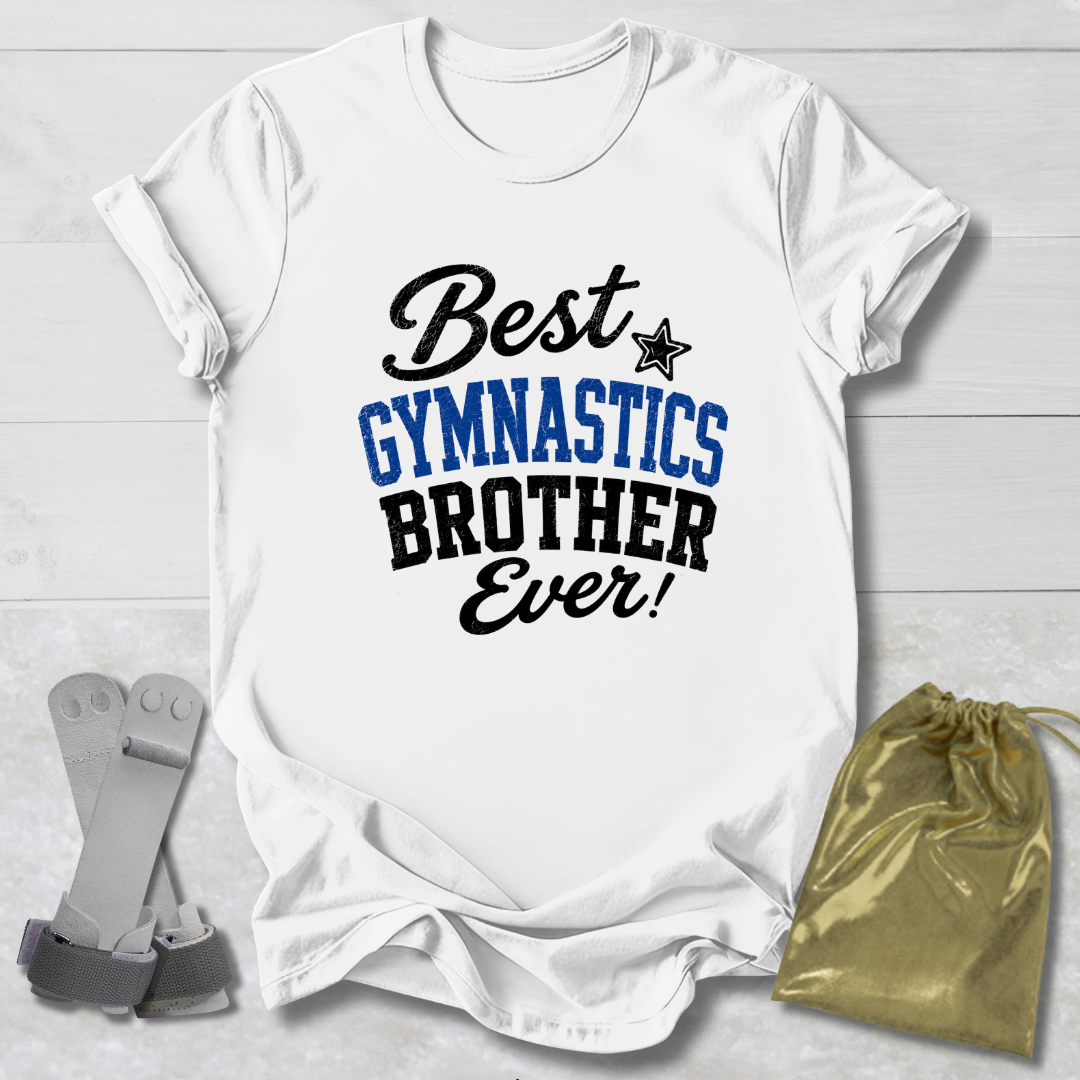 A white short-sleeve T-shirt laid flat on a light wood background, printed with the phrase 'Best GYMNASTICS BROTHER Ever!' in black and blue lettering. A small black star appears between 'Best' and 'GYMNASTICS.