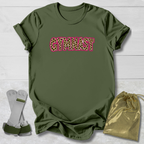 An olive green short-sleeve t-shirt with the word 'GYMNIST' printed across the chest in a pink-outlined leopard print. The shirt is displayed in a flat-lay arrangement on a white wood background, accompanied by a pair of white and green athletic straps and a gold drawstring bag.