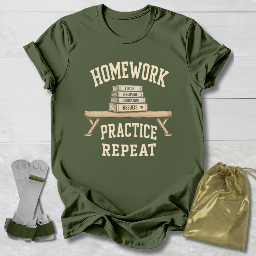 An olive green graphic t-shirt laid flat on a white wood background, featuring a cream-colored print that reads 'HOMEWORK PRACTICE REPEAT' with a stack of books and bench illustration. A pair of gray and green athletic wristbands and a gold drawstring pouch are placed beside the shirt.