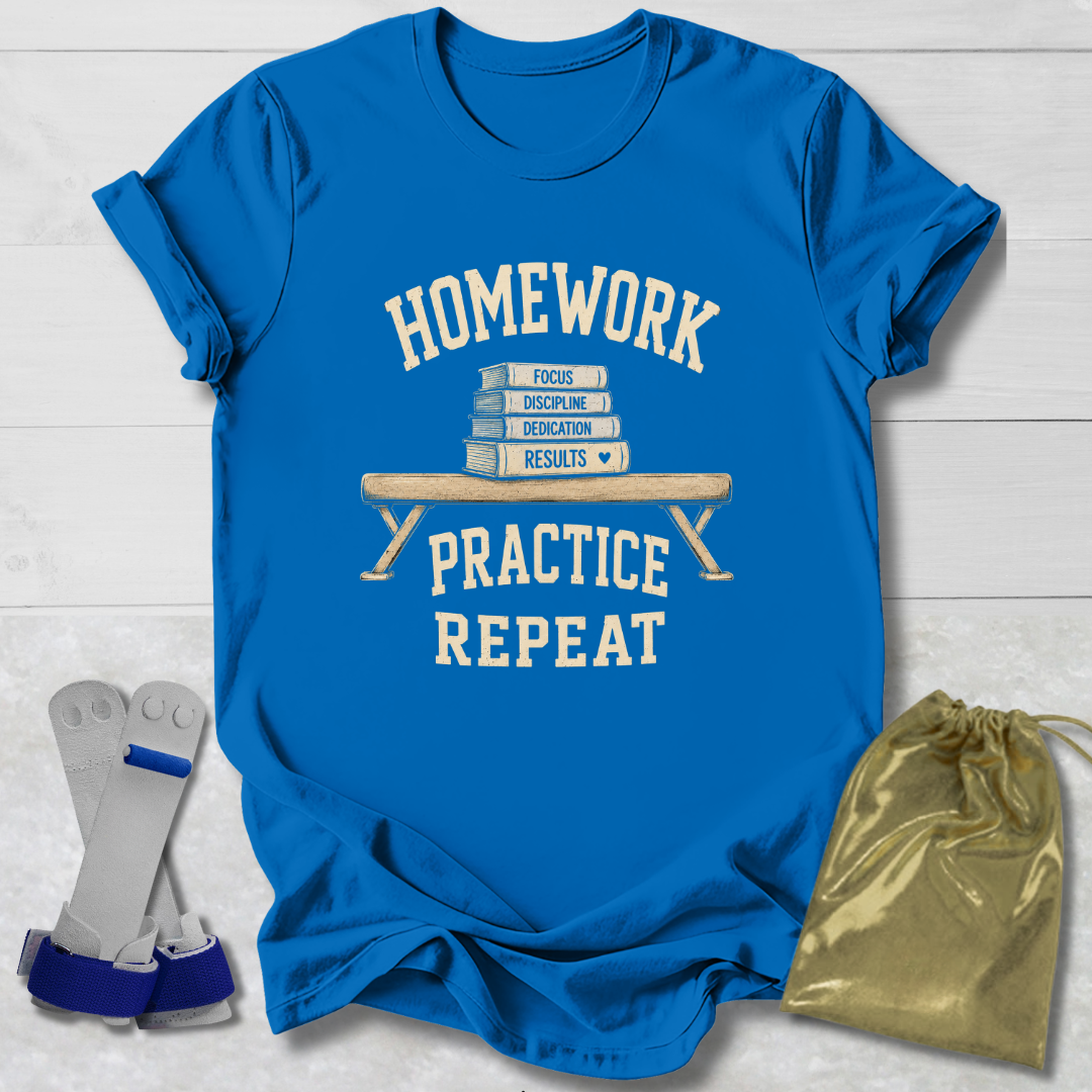 A bright blue graphic T-shirt laid flat on a white wood background, with cream text reading 'HOMEWORK PRACTICE REPEAT' and a stack of books on the front. Two small accessories are placed beside it: a pair of gray and blue wrist/ankle wraps on the left and a shiny gold drawstring pouch on the right.